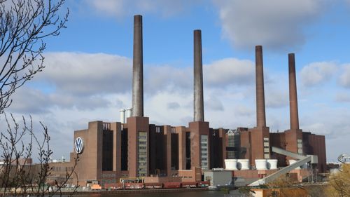 The four brick chimneys of the power station at Volkswagen's factory in Wolfsburg, Germany, under a blue sky